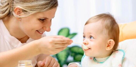 Mamá dando de comer a su bebé